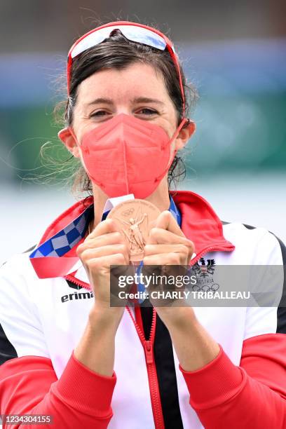 Bronze medalist Austria's Magdalena Lobnig poses on the podium following the women's single sculls final during the Tokyo 2020 Olympic Games at the...