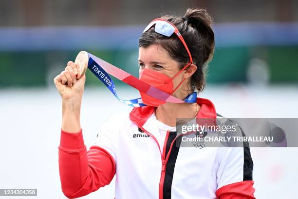 Bronze medalist Austria's Magdalena Lobnig poses on the podium following the women's single sculls final during the Tokyo 2020 Olympic Games at the...