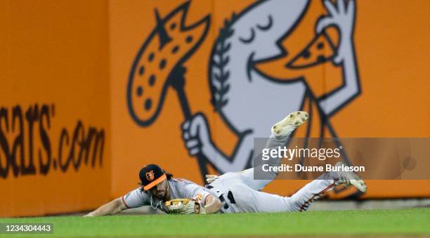 Left fielder Ryan McKenna of the Baltimore Orioles makes a diving catch of a fly ball hit by Willi Castro of the Detroit Tigers during the seventh...