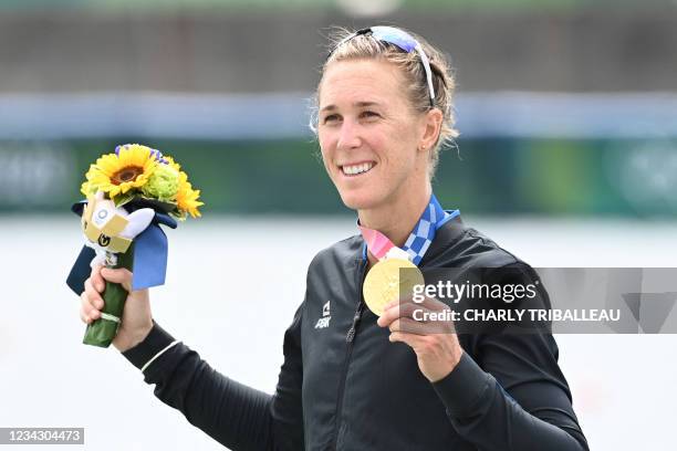 Gold medalist New Zealand's Emma Twigg poses on the podium following the women's single sculls final during the Tokyo 2020 Olympic Games at the Sea...