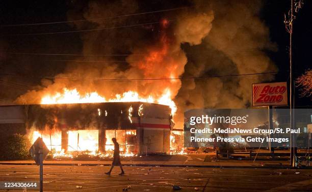 The Auto Zone store at Minnehaha Avenue and Lake Street burns in the early morning hours of May 28 in Minneapolis, Minnesota. Violent protests over...