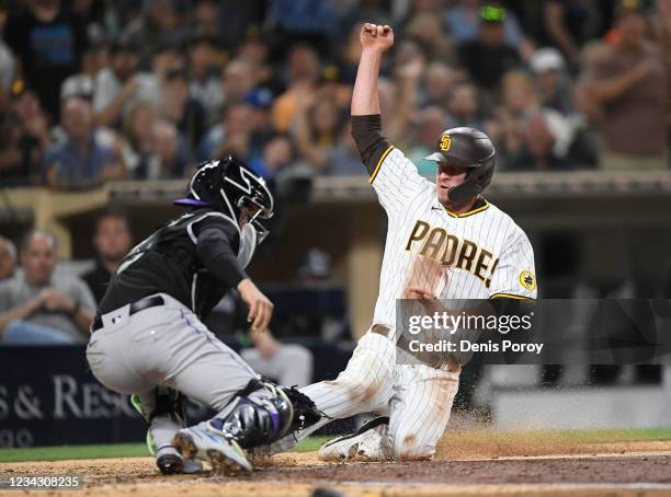 Wil Myers of the San Diego Padres is tagged out at the plate by Dom Nunez of the Colorado Rockies during the sixth inning of a baseball game at Petco...