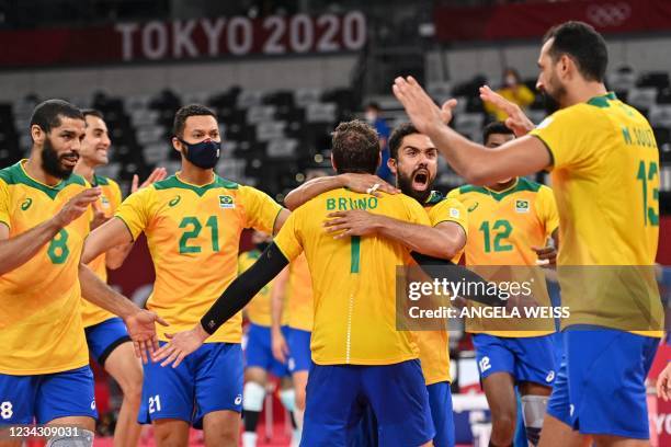 Brazil's players celebrate their victory in the men's preliminary round pool B volleyball match between Brazil and USA during the Tokyo 2020 Olympic...