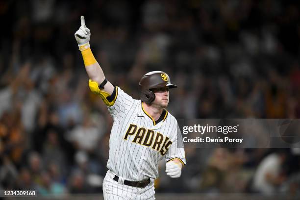 Jake Cronenworth of the San Diego Padres celebrates after hitting a two-run home run during the eighth inning of a baseball game against the Colorado...