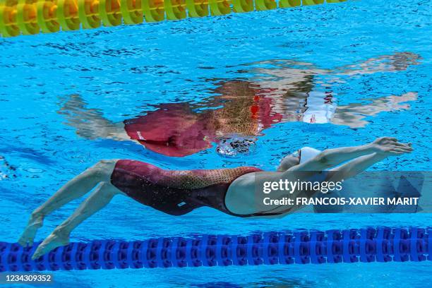 An underwater view shows China's Peng Xuwei competing in a semi-final of the women's 200m backstroke swimming event during the Tokyo 2020 Olympic...
