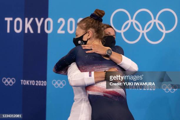 Britain's Bryony Page celebrates with her coach after competing in the women's final of the Trampoline Gymnastics event during Tokyo 2020 Olympic...