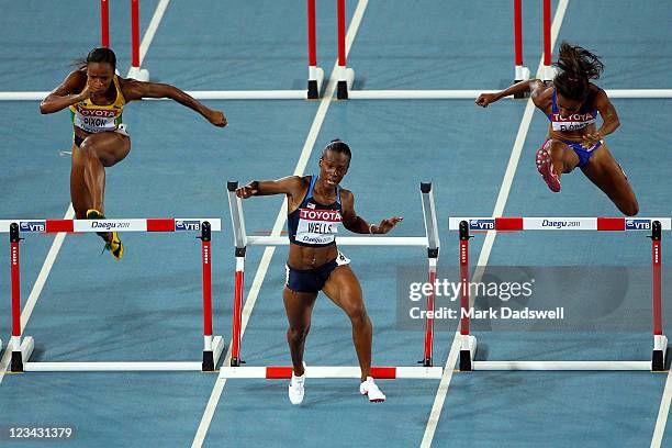 Vonette Dixon of Jamaica, Kellie Wells of United States and Lina Florez of Columbia compete in the women's 100 metres hurdles semi finals during day...