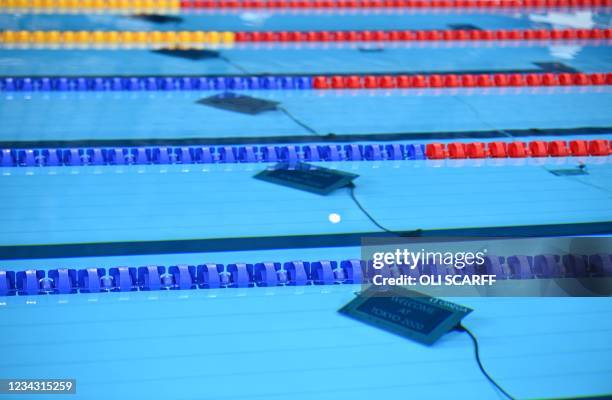 Digital displays are pictured on the floor of the pool ahead of a swimming event during the Tokyo 2020 Olympic Games at the Tokyo Aquatics Centre in...