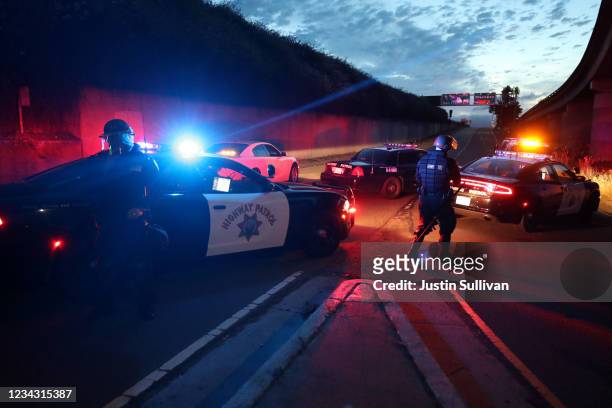 California Highway Patrol officers block a freeway entrance during a protest sparked by the death of George Floyd while in police custody on May 29,...
