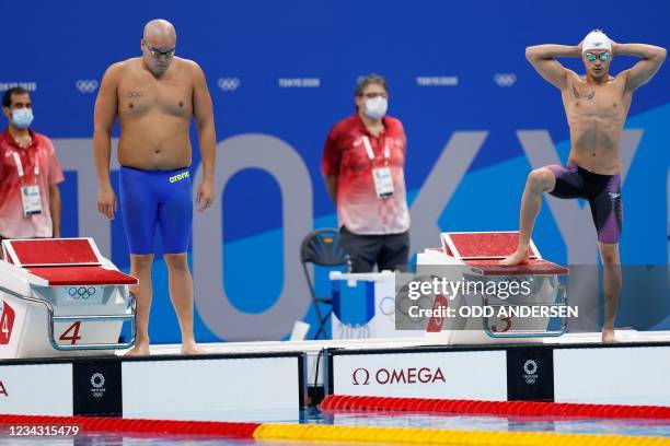 Afghanistan's Fahim Anwari and Palau's Shawn Dingilius Wallace prepare to compete in a heat for the men's 50m freestyle swimming event during the...