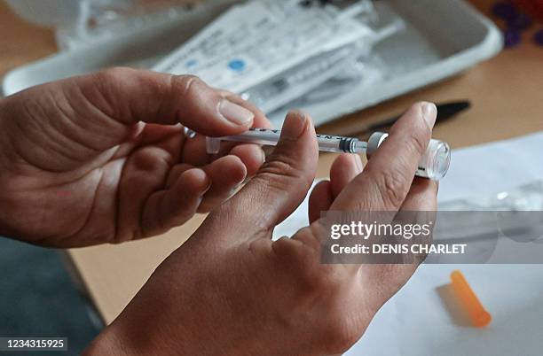 Doctor prepares a dose of the Pfizer/BioNTech Covid-19 vaccine at the prefecture in Lille, northern France, on July 30, 2021.