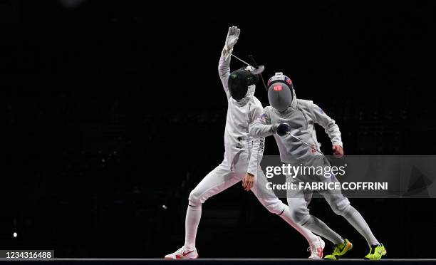 Japan's Uyama Satoru loose his epee as he compete against Russia's Pavel Sukhov in the men's epee team gold medal bout during the Tokyo 2020 Olympic...