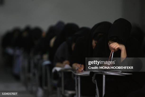 Iranian high school students sit for their university entrance examination in Tehran on June 25, 2009. Iran has jailed more than 140 political...