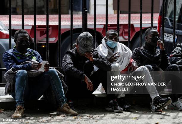 Migrants and homeless people wait to be relocated after spending the night in tents installed the day before during an action organised by the Utopia...