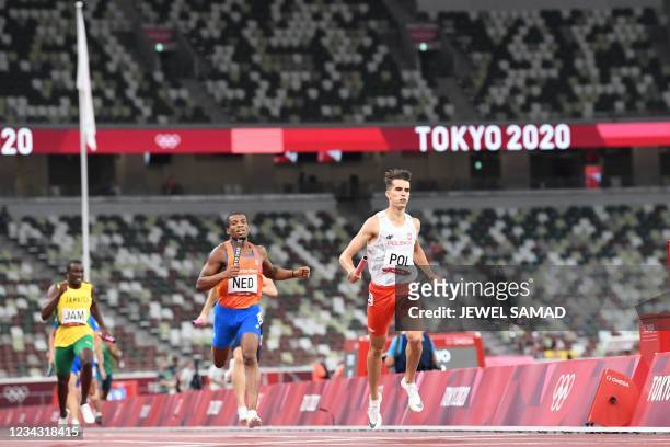 Poland's Kajetan Duszynski and Netherlands' Ramsey Angela and Jamaica's Karayme Bartley compete in the mixed 4x400m relay heats during the Tokyo 2020...