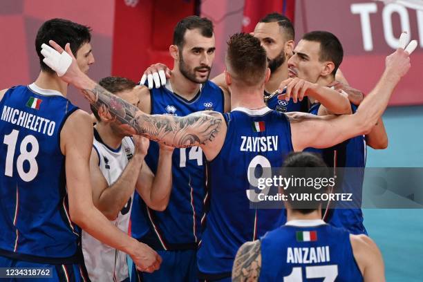 Italy's players react after a point in the men's preliminary round pool A volleyball match between Italy and Iran during the Tokyo 2020 Olympic Games...