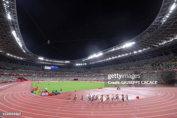 General view shows athletes competing in an empty stadium forthe men's 10000m final during the Tokyo 2020 Olympic Games at the Olympic Stadium in...