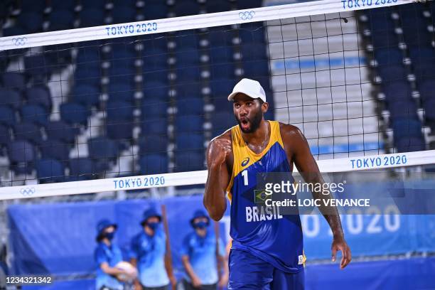 Brazil's Evandro Goncalves Oliveira Junior celebrates winning their men's preliminary beach volleyball pool E match between Poland and Brazil during...