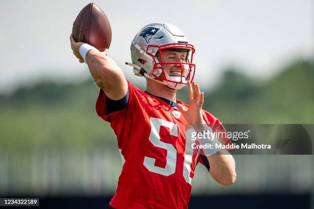 Mac Jones smiles as he throws during Training Camp at Gillette Stadium on July 30, 2021 in Foxborough, Massachusetts.