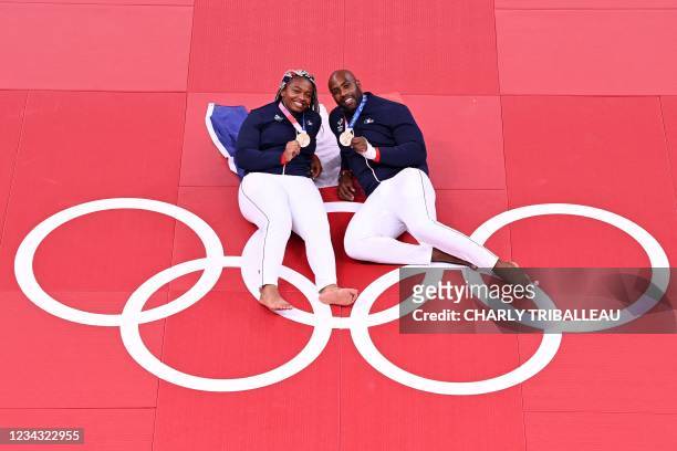 France's Judo bronze medalists Romane Dicko and Teddy Riner pose during the Tokyo 2020 Olympic Games at the Nippon Budokan in Tokyo on July 30, 2021.