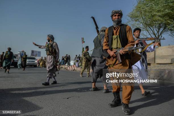 Afghan security personnel and Afghan militia fighting against Taliban, stand guard in Enjil district of Herat province on July 30, 2021.