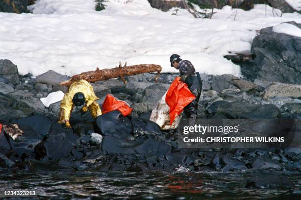 Workers clean up oil the Valdez coasts on April 2, 1989 after Exxon Valdez, an oil tanker owned by Exxon Shipping Company that was bound for Long...