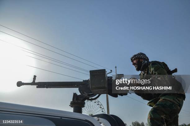 Afghan security personnel and Afghan militia fighting against Taliban, stand guard in Enjil district of Herat province on July 30, 2021.