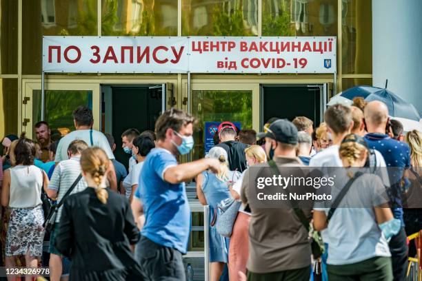 People wait in the entrance of the main coronavirus vaccination centre inKiev, Ukraine.