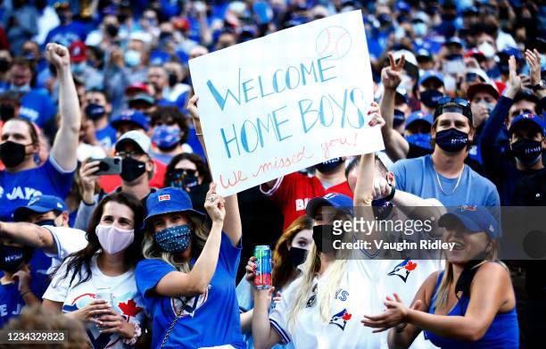 Toronto Blue Jays fans cheer as the team makes their way onto the field for their first home game in Toronto this season prior to a MLB game against...