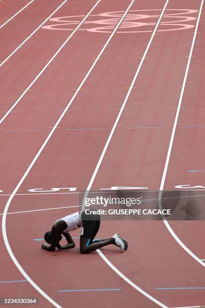 Refugee Olympic Team's James Nyang Chiengjiek reacts afte falling during the men's 800m heats during the Tokyo 2020 Olympic Games at the Olympic...