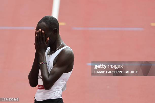 Refugee Olympic Team's James Nyang Chiengjiek reacts afte falling during the men's 800m heats during the Tokyo 2020 Olympic Games at the Olympic...