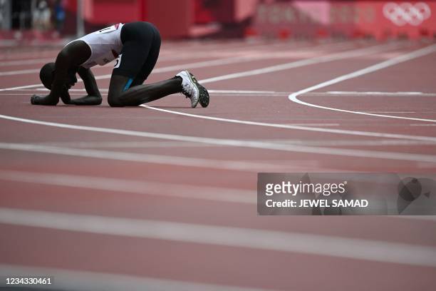 Refugee Olympic Team's James Nyang Chiengjiek reacts afte falling during the men's 800m heats during the Tokyo 2020 Olympic Games at the Olympic...