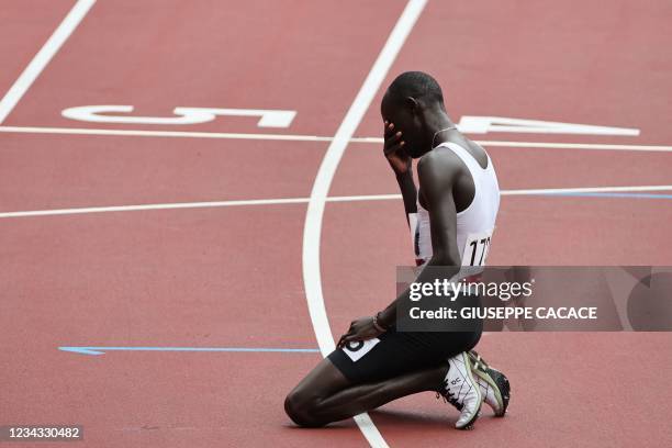 Refugee Olympic Team's James Nyang Chiengjiek reacts afte falling during the men's 800m heats during the Tokyo 2020 Olympic Games at the Olympic...