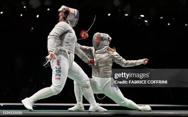 S Dagmara Wozniak compete against France's Charlotte Lembach in the womens team sabre quarter-final bout during the Tokyo 2020 Olympic Games at the...