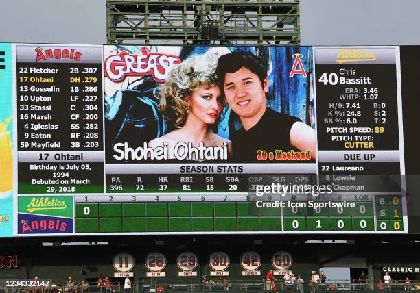 Los Angeles Angels designated hitter Shohei Ohtani appears on the scoreboard doing his at bat next to Olivia Newton-John as John Travolta's character...