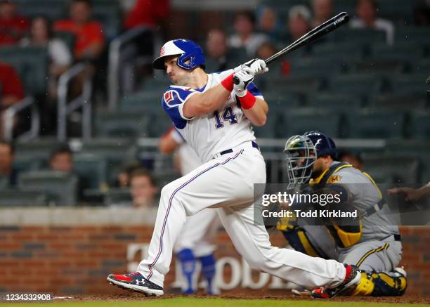 Adam Duvall of the Atlanta Braves hits an RBI single in the fifth inning of an MLB game against the Milwaukee Brewers at Truist Park on July 30, 2021...