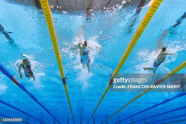 An underwater view shows USA's Kathleen Ledecky , USA's Katie Grimes and Italy's Simona Quadarella competing in the final of the women's 800m...