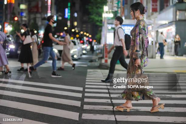 Woman dressed in Yukata walks towards Kabukicho, the biggest entertainment district in Tokyo. 3300 people have tested positive for the Novel...