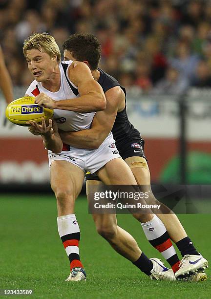 Clinton Jones of the Saints is tackled by Marc Murphy of the Blues during the round 24 AFL match between the Carlton Blues and the St Kilda Saints at...