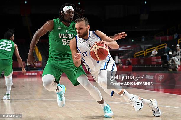 Italy's Stefano Tonut dribbles the ball past Nigeria's Precious Achiuwa in the men's preliminary round group B basketball match between Italy and...
