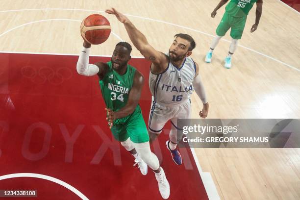 Nigeria's Ike Nwamu goes to the basket past Italy's Amedeo Tessitori in the men's preliminary round group B basketball match between Italy and...