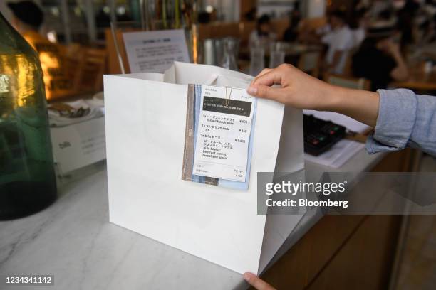 Take-out order at the checkout counter of a restaurant in Tokyo, Japan, on Saturday, July 31, 2021. Thanks to the resurgent pandemic, shares in the...