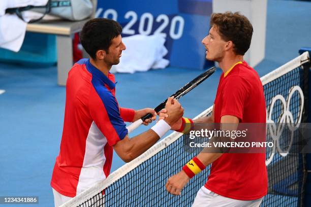 Spain's Pablo Carreno Busta shakes hand with Serbia's Novak Djokovic after winning the Tokyo 2020 Olympic Games men's singles tennis match for the...