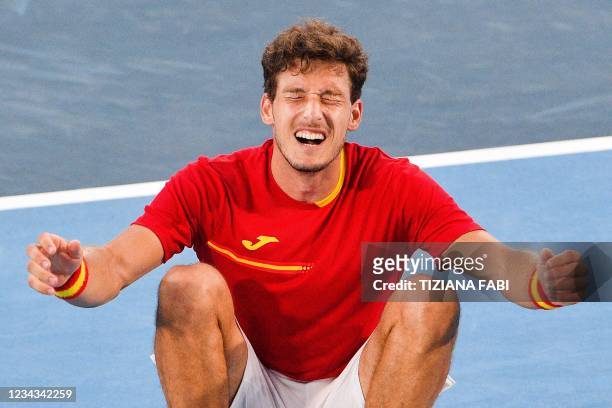 Spain's Pablo Carreno Busta celebrates after defeating Serbia's Novak Djokovic during their Tokyo 2020 Olympic Games men's singles tennis match for...