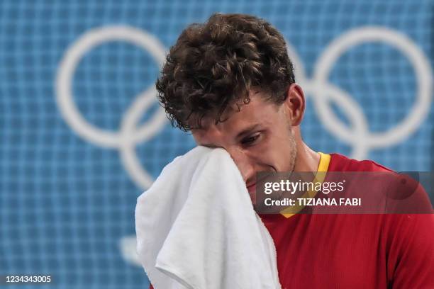 Spain's Pablo Carreno Busta reacts after defeating Serbia's Novak Djokovic during their Tokyo 2020 Olympic Games men's singles tennis match for the...