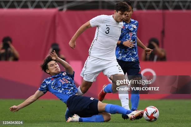 Japan's defender Daiki Hashioka fights for the ball with New Zealand's defender Liberato Cacace during the Tokyo 2020 Olympic Games men's...