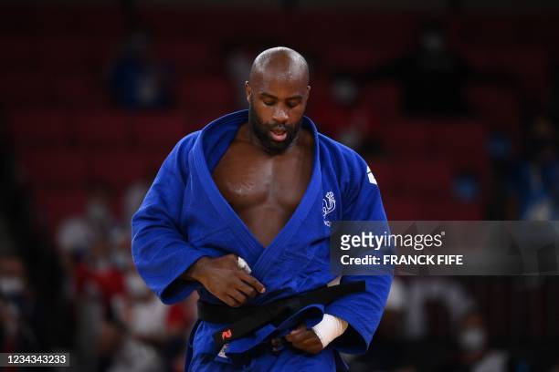 France's Teddy Riner reacts after defeating Japan's Aaron Wolf in the judo mixed team's final bout during the Tokyo 2020 Olympic Games at the Nippon...