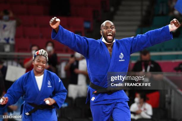 France's Teddy Riner and France's Romane Dicko celebrate winning gold in the judo mixed team's final bout against Japan during the Tokyo 2020 Olympic...