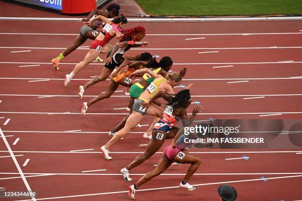 Athletes take the start in the women's 400m hurdles heats during the Tokyo 2020 Olympic Games at the Olympic Stadium in Tokyo on July 31, 2021.