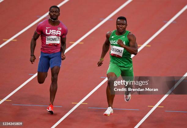 Tokyo , Japan - 31 July 2021; Enoch Adegoke of Nigeria, right, and Trayvon Bromell of USA in action during round one of the men's 100 metres at the...